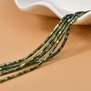 Macro shot of 2mm hexagonal hematite beads in green and bronze for jewelry making