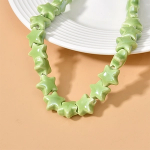 Close-up of light green ceramic star-shaped beads for DIY jewelry making