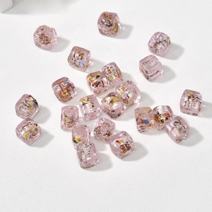 Detail of pink vintage cubic glass beads with colorful foil for DIY jewelry making