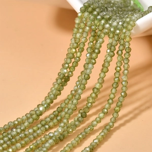 Close-up of 2mm olive green faceted zircon beads for DIY jewelry making and necklaces