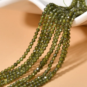 Close-up of 2mm dark green faceted zircon beads for DIY jewelry making and crafts