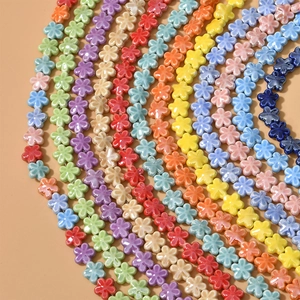 Macro view of colorful ceramic five-petal flower beads for DIY jewelry making