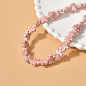 Delicate pink ceramic flower beads necklace with smooth glazed finish for DIY jewelry