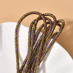 Close-up of 4mm wave disc hematite beads with iridescent metallic finish for DIY jewelry
