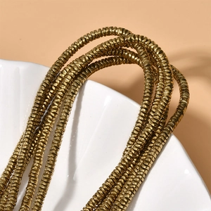 Macro shot of 4x1mm gold-plated hematite wave disc spacer beads for jewelry making
