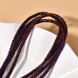 Macro detail of 4x1mm wavy purple metallic hematite spacer beads for DIY jewelry making
