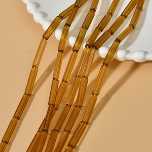 Vue macro de perles tubes ambrées translucides pour la création de bijoux DIY élégants