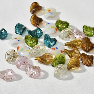 Dettaglio macro di perle di vetro irregolari artistiche con foglia d'oro per gioielli