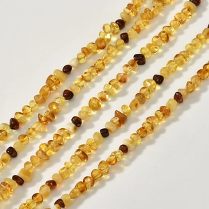 Irregular amber beads necklace featuring assorted natural yellow and brown stone chips