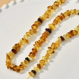 Natural amber stone necklace with irregular polished beads in various warm golden tones