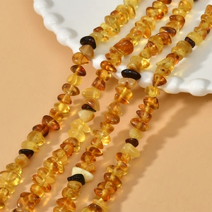 Macro shot of irregular natural amber beads strings for DIY jewelry and necklaces