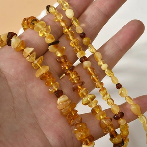 Close-up of handmade natural amber beaded necklace with various irregular yellow stones