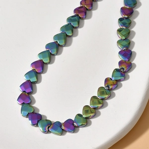 Macro shot of 6mm faceted heart-shaped beads with iridescent chameleon plating finish