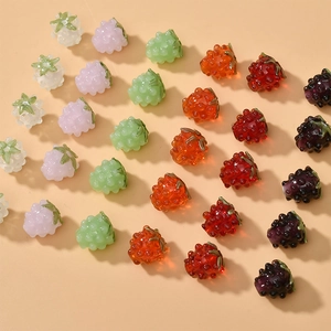 Detailed view of colorful raspberry-shaped glass beads for DIY jewelry making