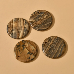Macro detail of 30mm round picture jasper stone pendants with natural landscape texture