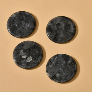 Detailed view of four round labradorite natural stone pendants with precut drill holes