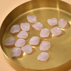 DIY jewelry pink petal beads with leaf vein texture in a golden metal tray