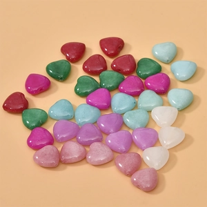 Detailed view of colorful heart-shaped natural stone beads for DIY jewelry making