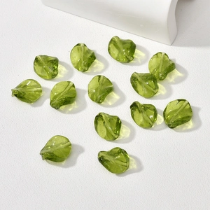 Macro shot of olive green irregular glass leaf beads for DIY jewelry making