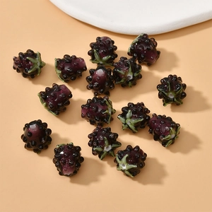 Detailed macro view of purple berry-shaped handmade glass beads for DIY jewelry making