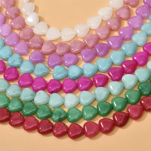 Macro shot of colorful heart-shaped natural stone beads for DIY jewelry crafting