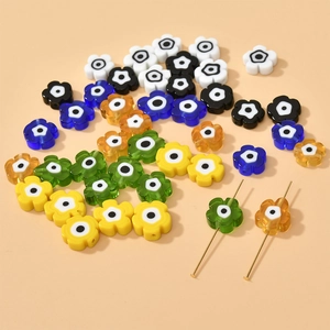 Macro shot of colorful flower-shaped evil eye beads for DIY handmade jewelry crafts
