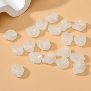 Macro shot of irregular milky white glass leaf beads for DIY jewelry making and crafts