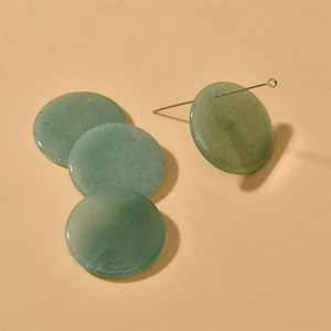 Detailed view of 30mm round green aventurine stone pendants with polished finish