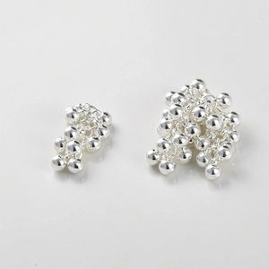 Macro detail of silver grape cluster beaded charms for DIY jewelry making accessories