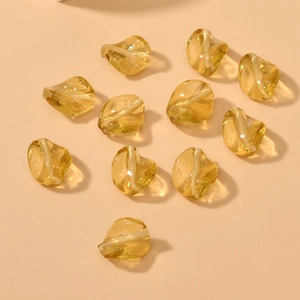 Close-up of amber yellow twisted irregular glass beads with straight holes for DIY jewelry