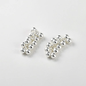 Macro detail of polished silver grape cluster beads for DIY jewelry making accessories