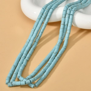 Vue macro détaillée de perles cylindriques turquoise avec texture marbrée brune