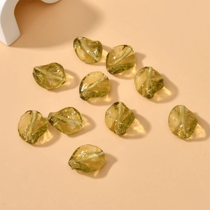 Close-up of translucent yellow-green irregular glass beads for DIY jewelry making