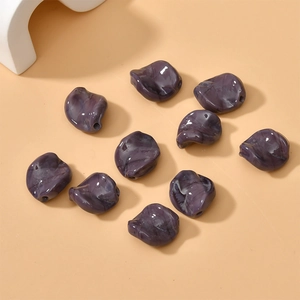 Macro detail of irregular purple marble resin leaf beads for DIY handmade jewelry crafts