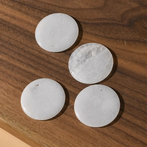 Macro view of 30mm round white agate stones with pre-drilled holes for DIY jewelry making