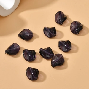 Macro shot of 10 purple translucent irregular twisted leaf beads for DIY jewelry making