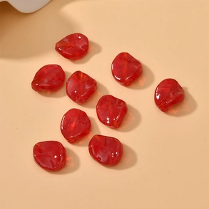 Macro shot of 9 red translucent irregular glass leaf beads for DIY jewelry making