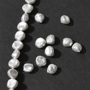Macro close-up of white Baroque irregular petal-shaped pearls with a natural luster finish