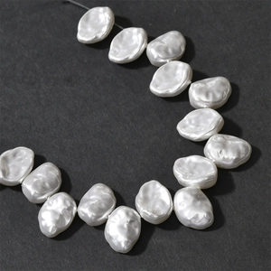 Macro detail of white Baroque pearl petals with natural texture for DIY jewelry making