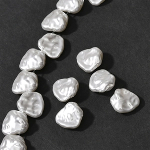 Macro shot of irregular white baroque pearl petals with natural texture for DIY jewelry