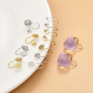 Detail of gold and silver clip-on earring converters with flat pad and ball loop