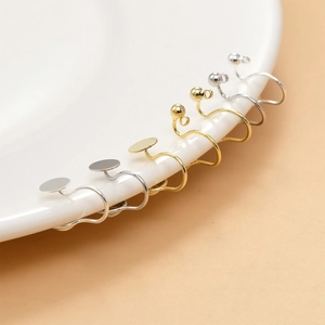 Detailed view of gold and silver plated clip-on earring converters for DIY jewelry making