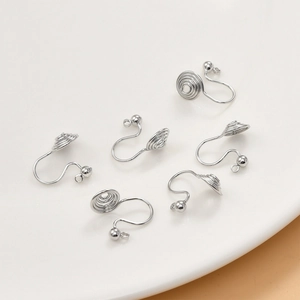 Close-up of silver screw-back earring clips for DIY jewelry making on white base