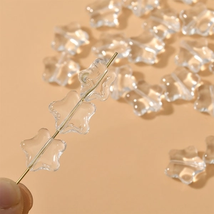 Close-up of 12mm frosted star-shaped Czech glass beads with AB coating for DIY jewelry