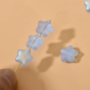 Close-up of 12mm blue matte frosted star beads with iridescent AB coating for DIY jewelry