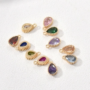 Close-up of 11 colorful pear-cut zircon teardrop pendants with 14k gold plated settings