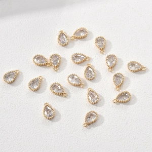 Close-up of 14k gold-plated teardrop charms with cubic zirconia for DIY jewelry making