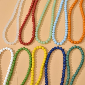 Close-up of 8mm colorful round glass beads in various vibrant colors for DIY jewelry making