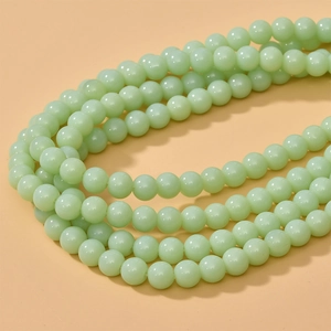 Strand of 8mm round mint green glass beads with smooth finish for DIY jewelry making