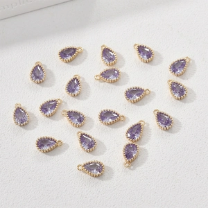 Macro shot of 14k gold-plated pear-shaped purple zircon pendants for DIY jewelry